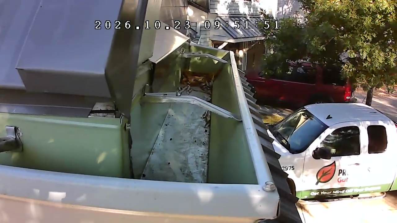 Close-up view inside a gutter showing the support brackets and accumulated debris, photographed from the ground with our inspection camera