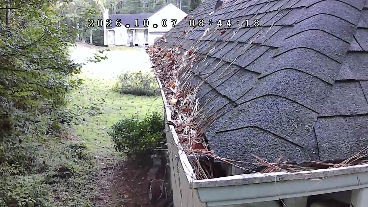 Gutter full of debris before cleaning at a North Georgia home