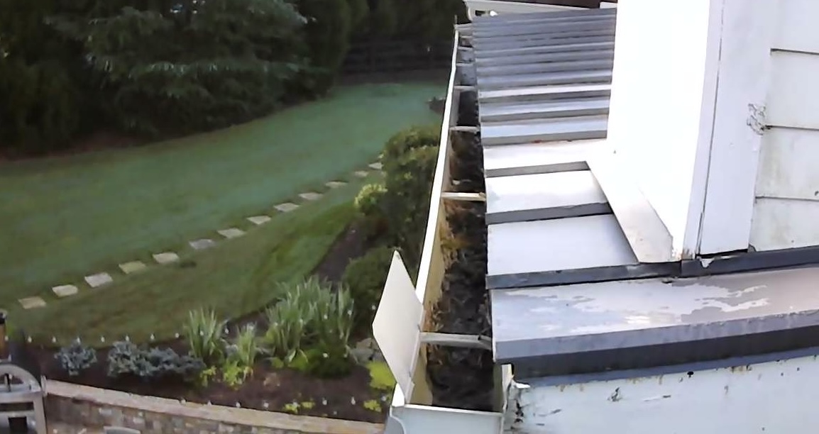 Debris-filled gutter before professional cleaning at an Alpharetta, Georgia home